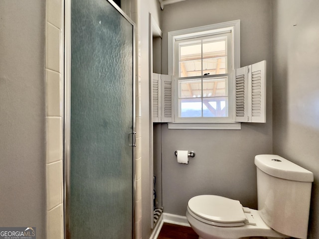 bathroom with walk in shower and toilet