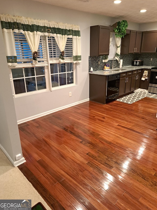 1440 Steam Engine Way NE, Conyers, GA 30013 - kitchen with black dishwasher, dark wood-style flooring, decorative backsplash, stainless steel stove, and recessed lighting