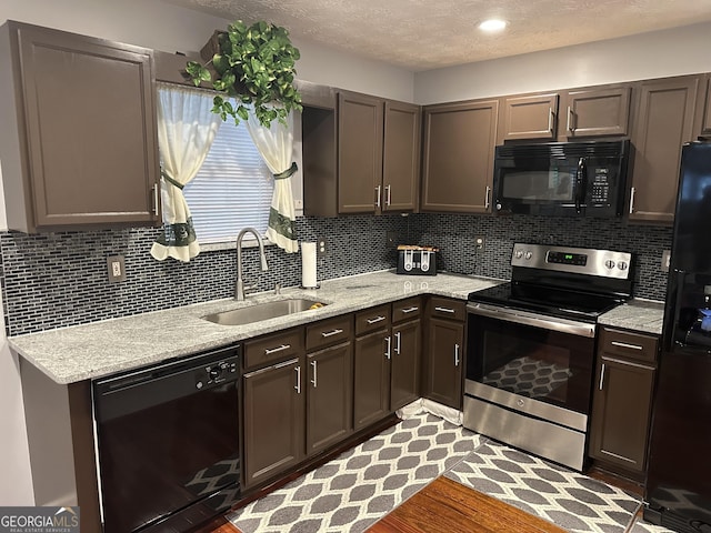 1440 Steam Engine Way NE, Conyers, GA 30013 - kitchen featuring black appliances, decorative backsplash, a textured ceiling, light stone counters, and dark brown cabinets