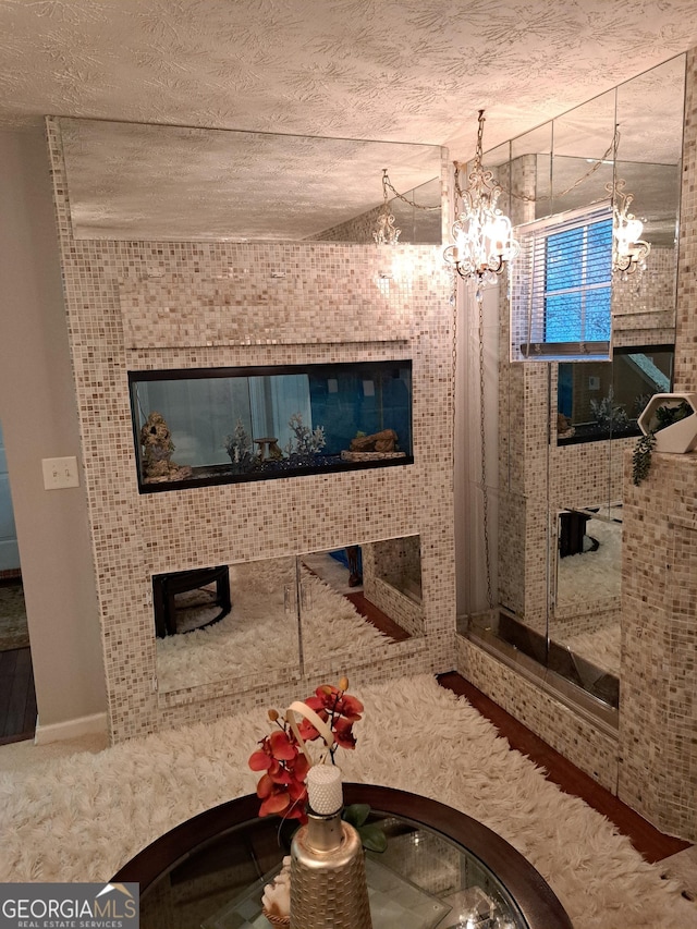 bathroom with a chandelier and a textured ceiling