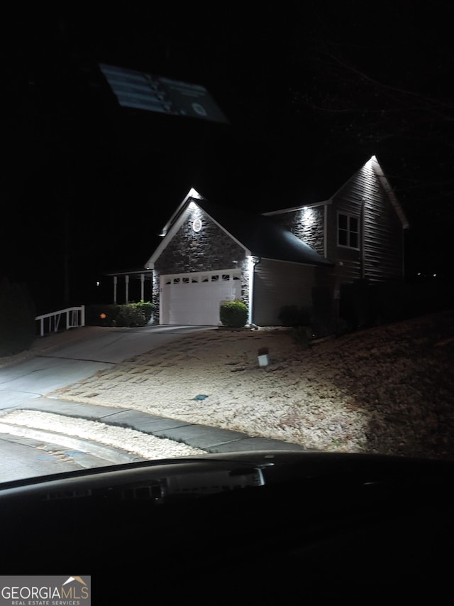 1440 Steam Engine Way NE, Conyers, GA 30013 - view of front facade with stone siding, driveway, and an attached garage
