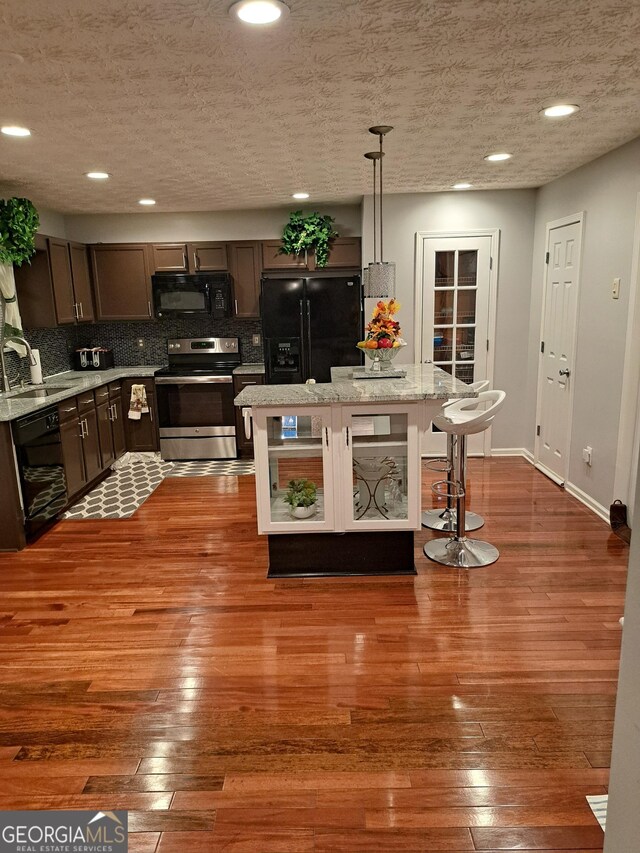 bathroom with shower with separate bathtub, hardwood / wood-style floors, and a textured ceiling