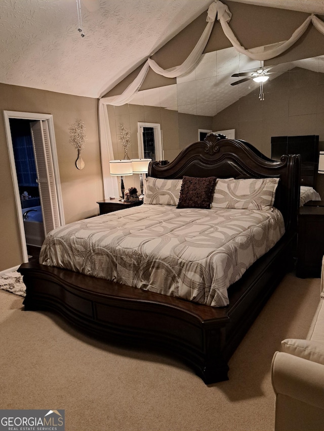 bedroom featuring lofted ceiling, ceiling fan, a textured ceiling, and carpet flooring