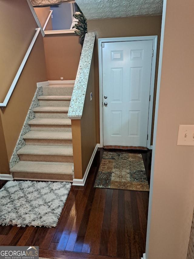 doorway to outside featuring baseboards, stairway, and hardwood / wood-style floors