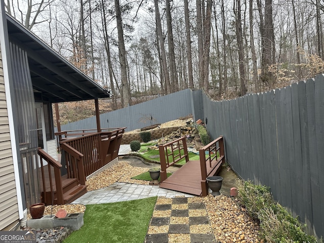 view of yard with a deck and a patio area