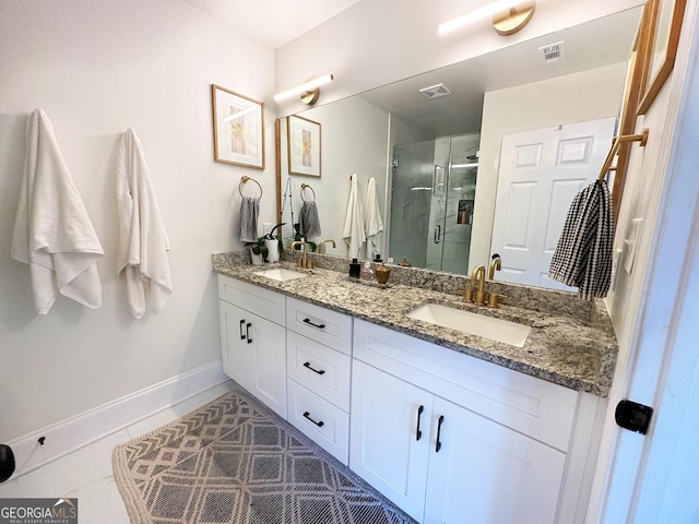 bathroom with tile patterned flooring, vanity, and an enclosed shower