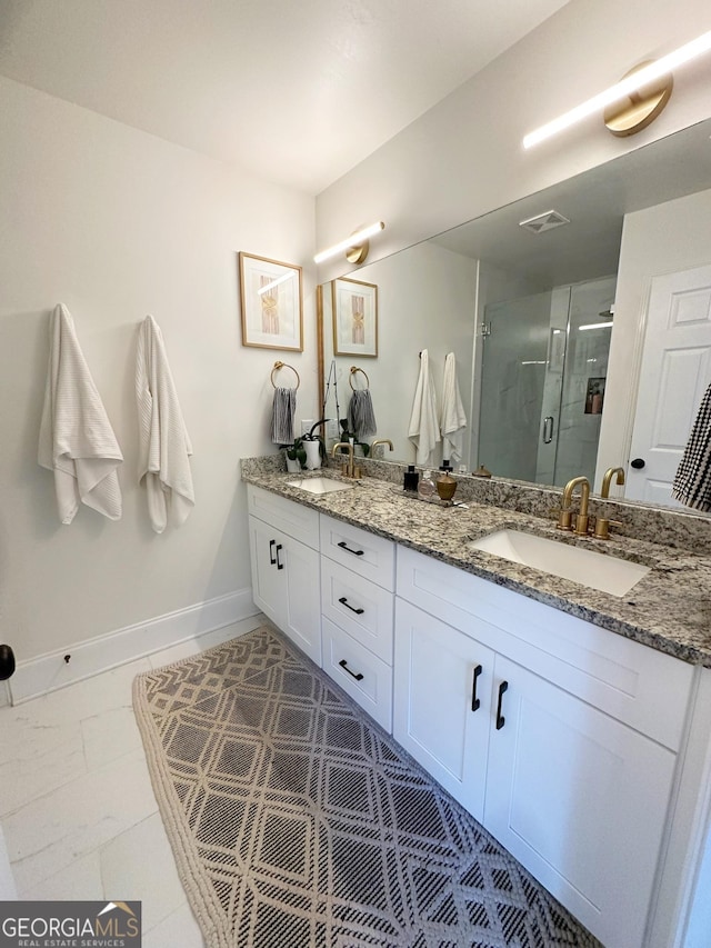 bathroom with tile patterned flooring, vanity, and an enclosed shower