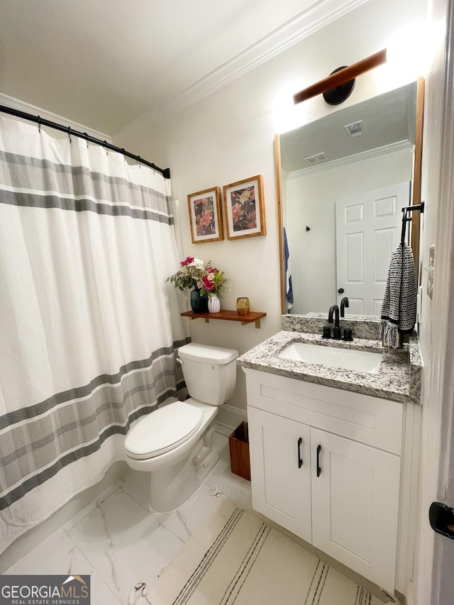 bathroom featuring crown molding, vanity, and toilet