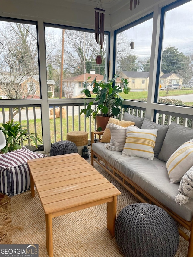 sunroom with a water view and plenty of natural light