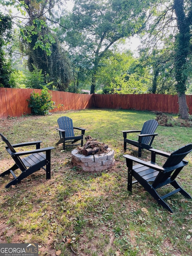 view of yard with an outdoor fire pit