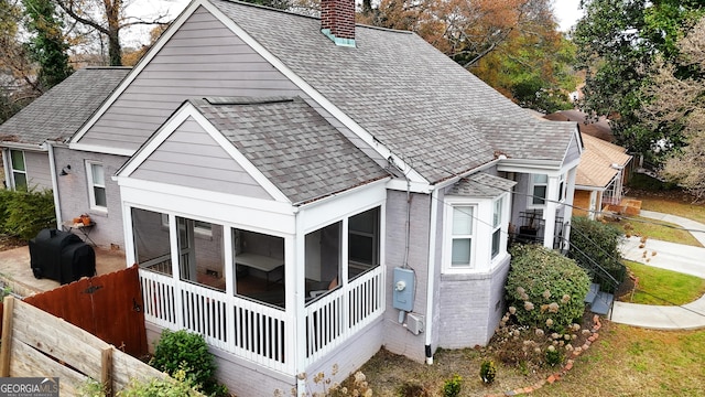 back of house featuring a sunroom