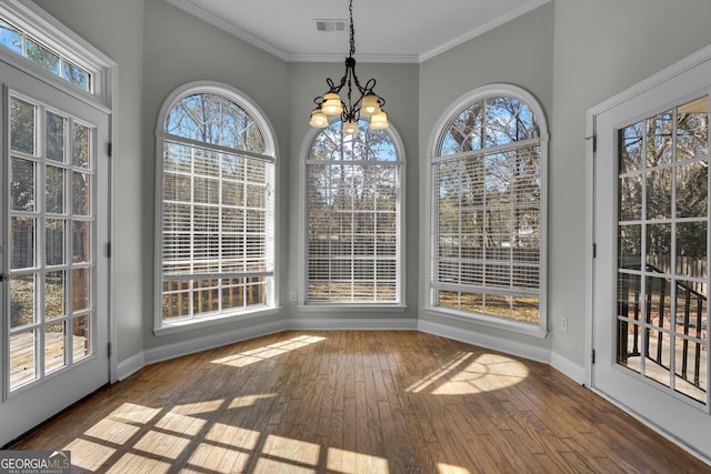 unfurnished sunroom with plenty of natural light and a chandelier