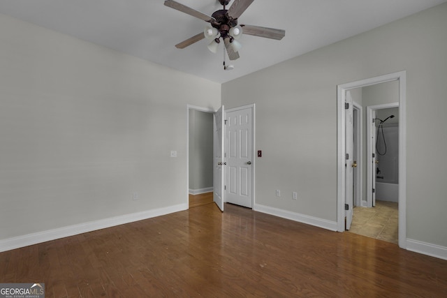 unfurnished bedroom with wood-type flooring, ceiling fan, and ensuite bathroom