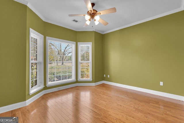 empty room featuring ceiling fan, ornamental molding, and light hardwood / wood-style floors