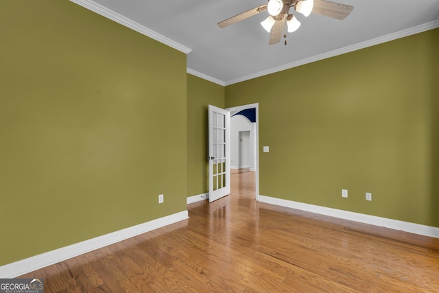 empty room featuring crown molding, ceiling fan, and light hardwood / wood-style floors