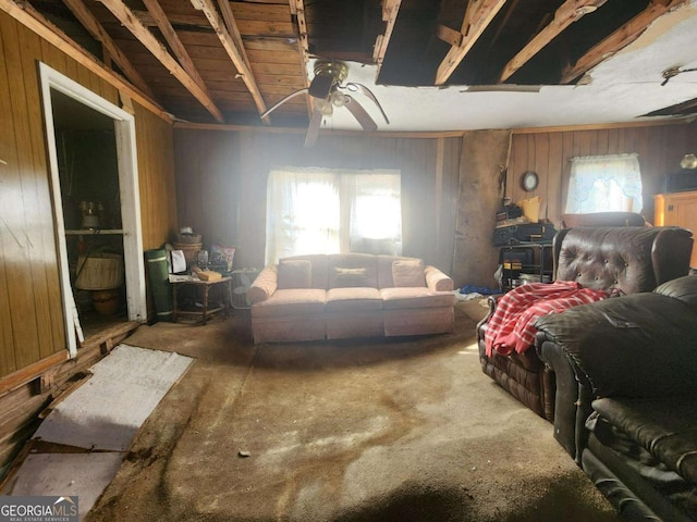 living room with ceiling fan and wooden walls