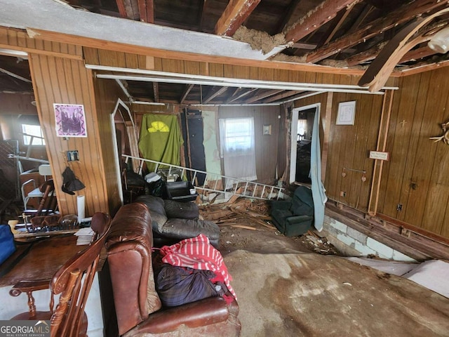 basement featuring wooden walls