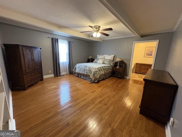 bedroom with crown molding, ceiling fan, a textured ceiling, and light wood-type flooring