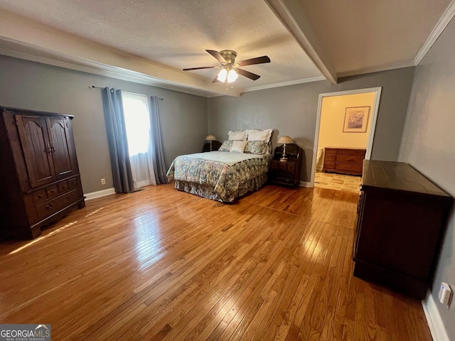 bedroom featuring crown molding, ceiling fan, light hardwood / wood-style floors, and a textured ceiling