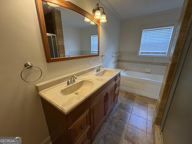 bathroom with vanity, ornamental molding, and a tub