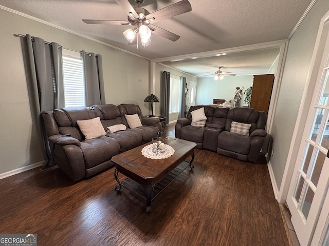 living room featuring ceiling fan, crown molding, dark wood-type flooring, and a textured ceiling