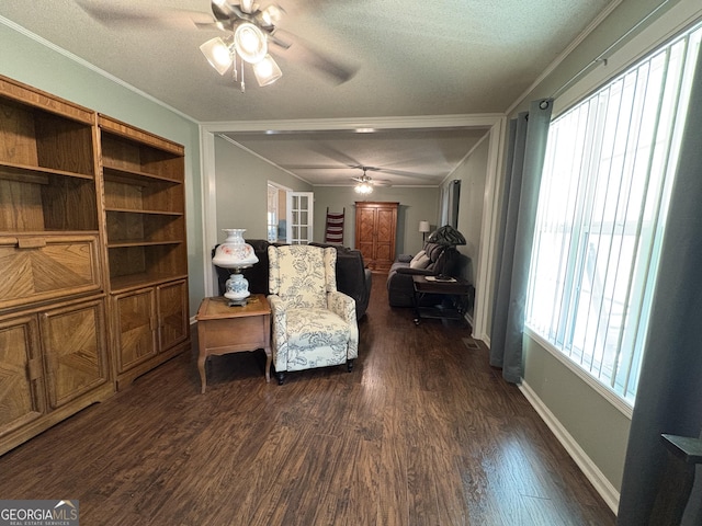 sitting room featuring ornamental molding, dark wood-type flooring, ceiling fan, and a textured ceiling