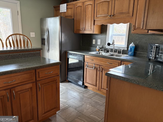 kitchen featuring sink, backsplash, and black dishwasher