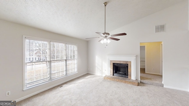 unfurnished living room with light carpet, a fireplace, a textured ceiling, and vaulted ceiling