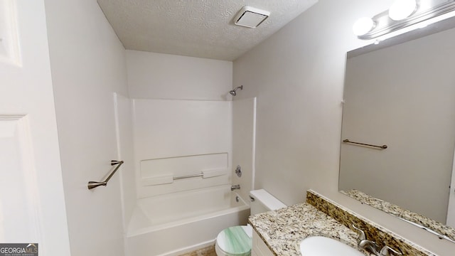 full bathroom featuring shower / washtub combination, toilet, a textured ceiling, and vanity