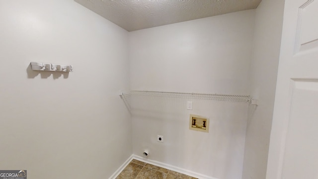 laundry area with washer hookup, hookup for an electric dryer, and a textured ceiling