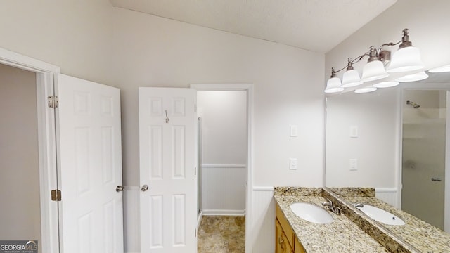 bathroom featuring vaulted ceiling, vanity, and a shower with shower door