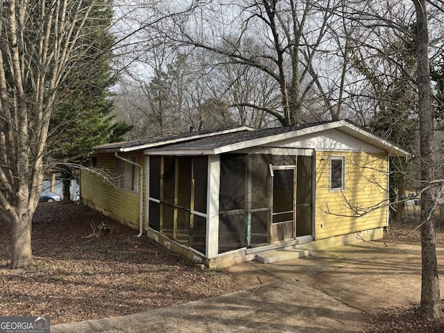 view of outdoor structure featuring a sunroom