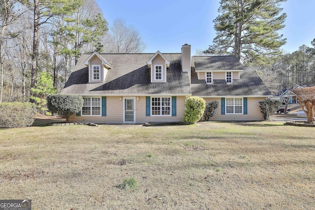 cape cod house with a front yard