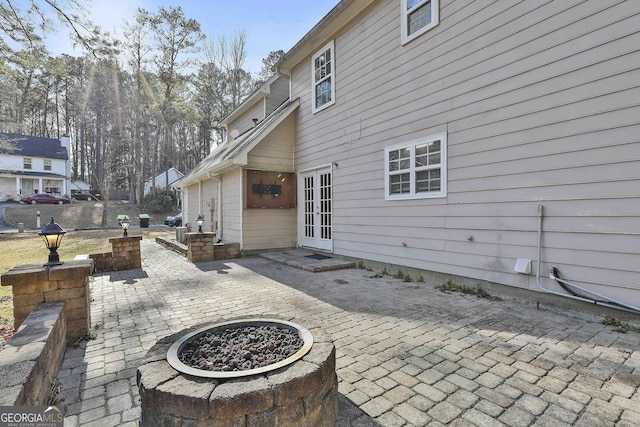 view of patio / terrace featuring a fire pit and french doors