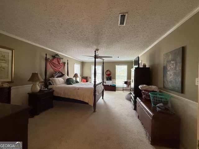 bedroom with ornamental molding, carpet flooring, a textured ceiling, and ceiling fan