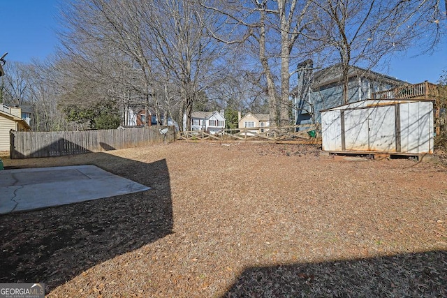 view of yard featuring a storage unit and a patio area