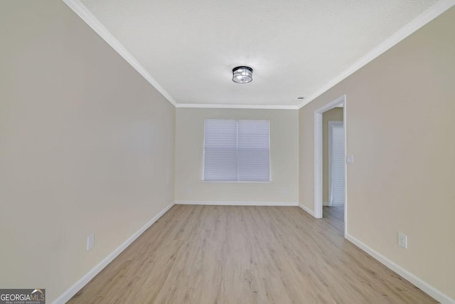 empty room featuring light hardwood / wood-style flooring and ornamental molding