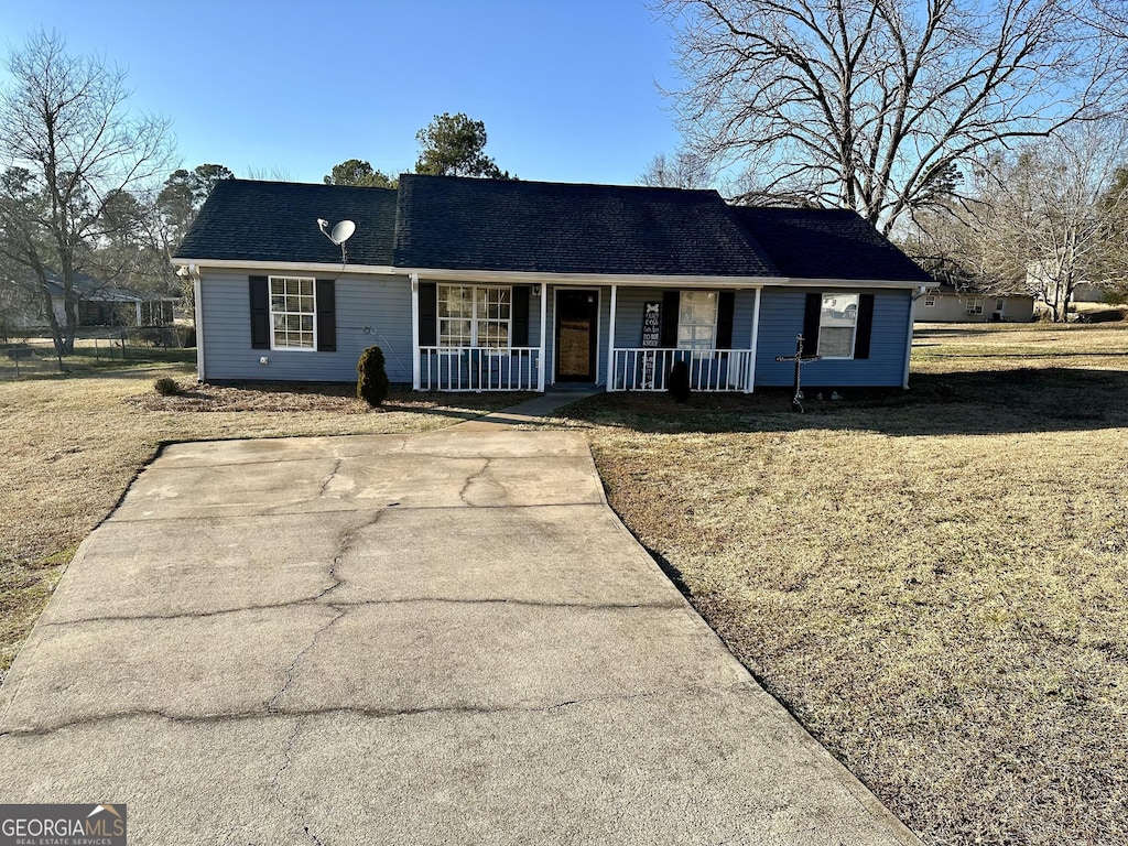 ranch-style house featuring a porch and a front yard