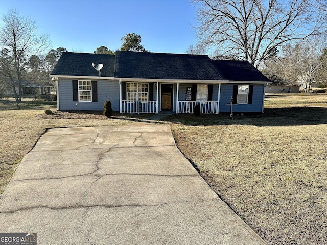 ranch-style house featuring a porch and a front yard