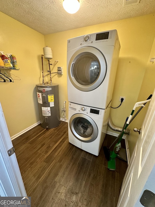 laundry room with stacked washer / drying machine, dark hardwood / wood-style flooring, electric water heater, and a textured ceiling