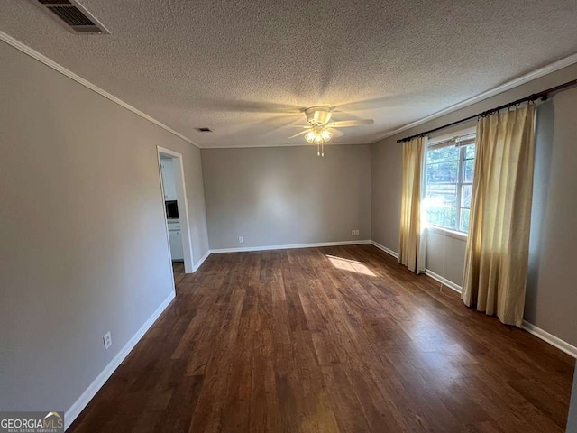 empty room with crown molding, a textured ceiling, dark hardwood / wood-style floors, and ceiling fan