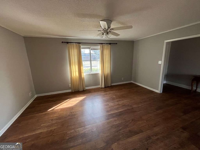 spare room featuring dark hardwood / wood-style flooring, a textured ceiling, ornamental molding, and ceiling fan