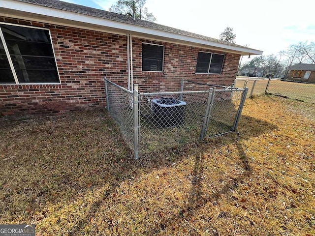 view of side of home with a yard and central air condition unit