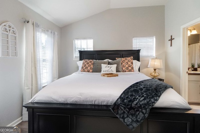 bedroom with lofted ceiling and ensuite bathroom