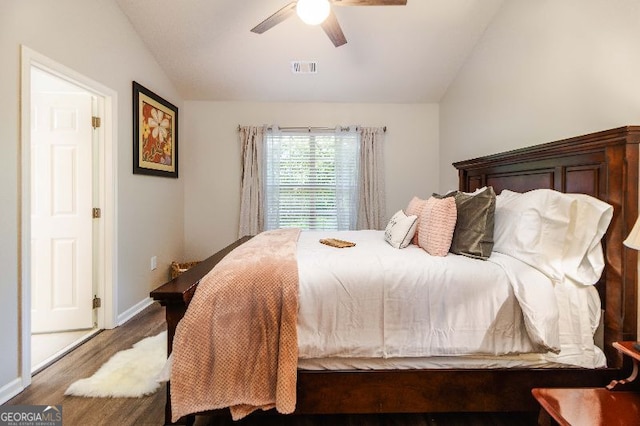 bedroom with hardwood / wood-style flooring, ceiling fan, and vaulted ceiling