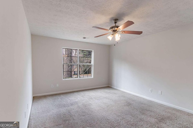 carpeted empty room featuring a textured ceiling and ceiling fan