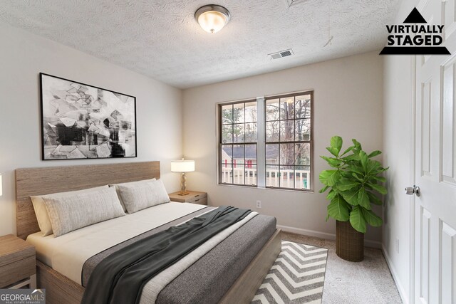 carpeted spare room with a textured ceiling