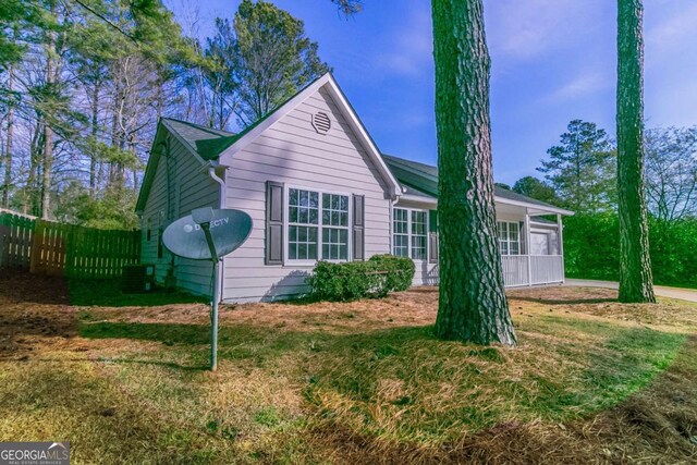 single story home featuring central AC unit and a front lawn