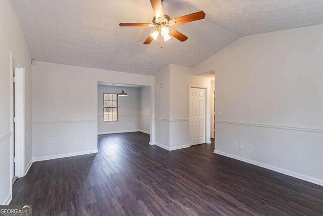 unfurnished dining area featuring dark wood-type flooring, a healthy amount of sunlight, and a textured ceiling