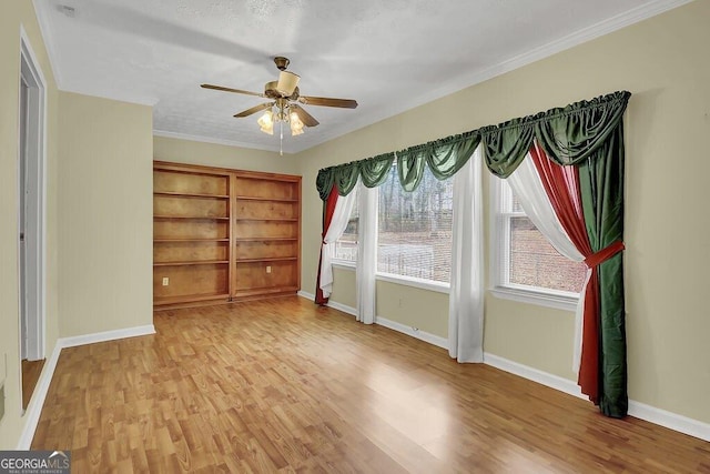 spare room featuring crown molding, ceiling fan, and hardwood / wood-style floors